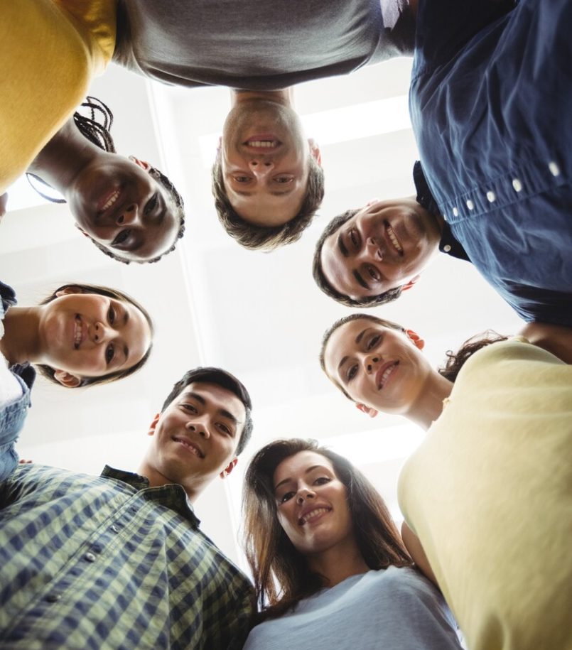 Group of business executives forming huddle